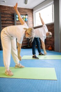 Person performing gentle back pain stretching exercises at home